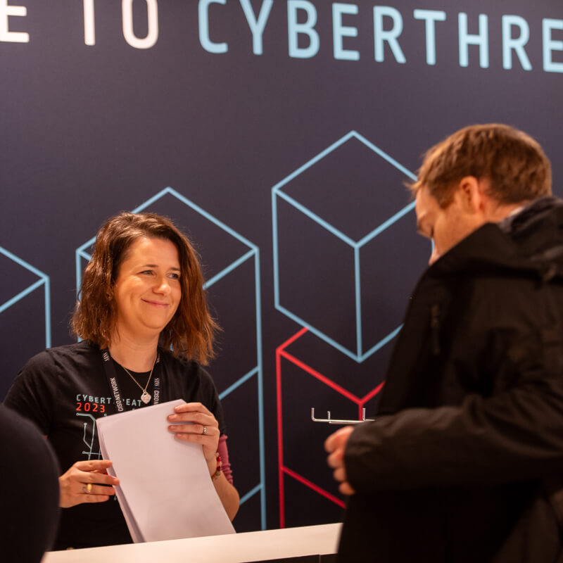 Person on the welcome desk at CyberThreat 2023